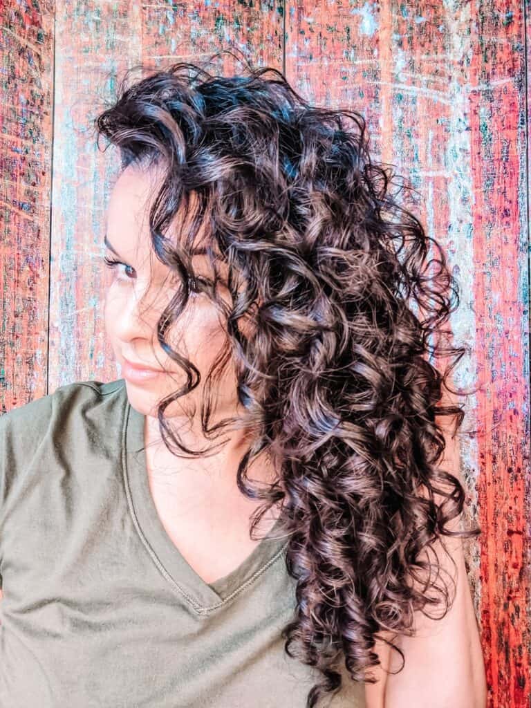 Delilah's hair styled and shown from the side after using EVOLVh SmartCurl results 2c curly hair