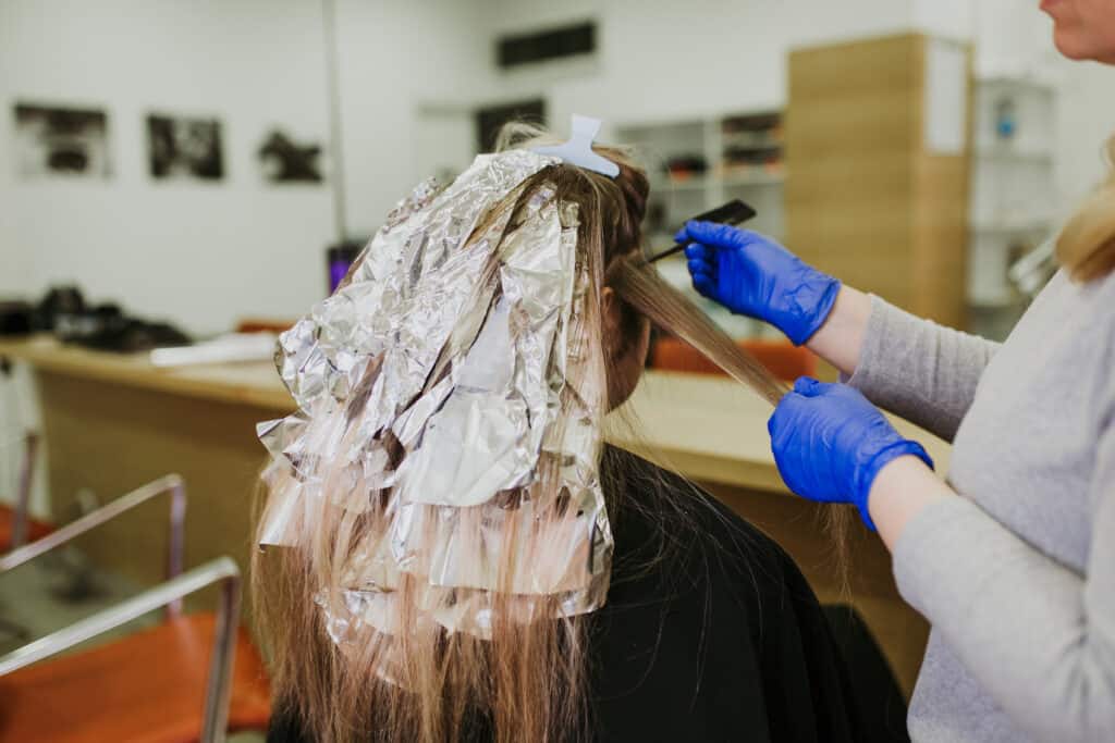 woman at the salon lightening dark hair