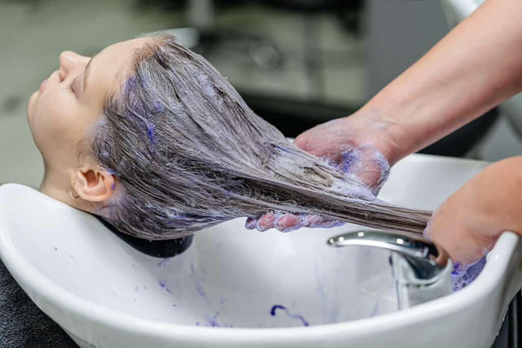 toning brown hair with purple shampoo at the salon