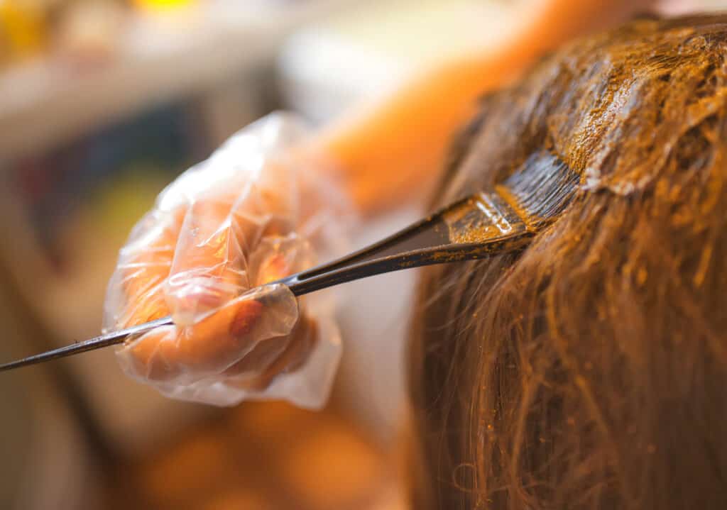 applying henna hair dye to hair